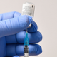 A member of staff uses a needle and a vial of Pfizer-BioNTech Covid-19 vaccine to prepare a dose at a vaccination health center in Cardiff, South Wales’ on December 8, 2020.